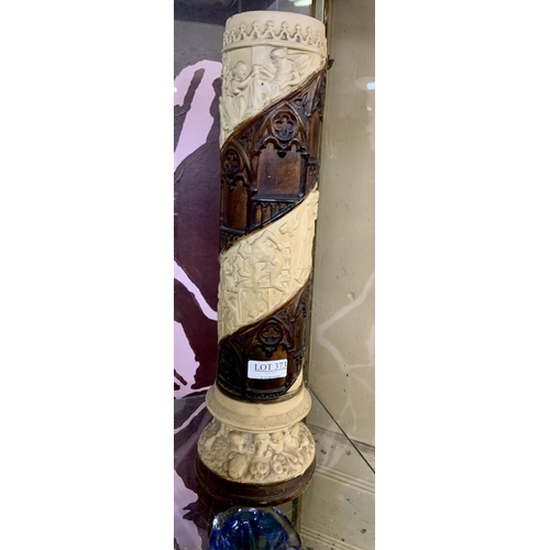 373 - A PLASTER CYLINDER VASE WITH MEDIEVAL STYLE FIGURES IN A SPIRAL PATTERN