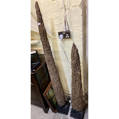 384 - PAIR OF ERODED CEDAR MUSSEL POLES ON BLACK SQUARE PLINTHS