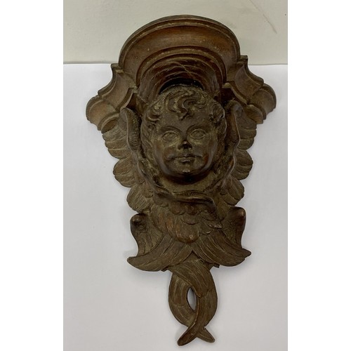 235 - A WOODEN WALL BRACKET DECORATED WITH A CHERUBS HEAD - H:19.5CMS