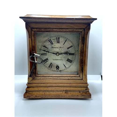 343 - A MORATH BROS. OF LIVERPOOL OAK CASED BRACKET CLOCK WITH KEY - WOUND AND WORKING WHEN TRIED