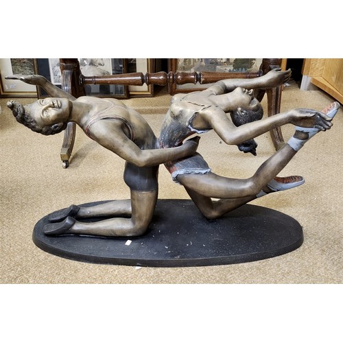 192 - BRONZE FIGURATIVE TABLE BASE - A PAIR OF CIRCUS ACROBATS IN THE FORM OF A TABLE BASE ON AN OVAL SUPP... 