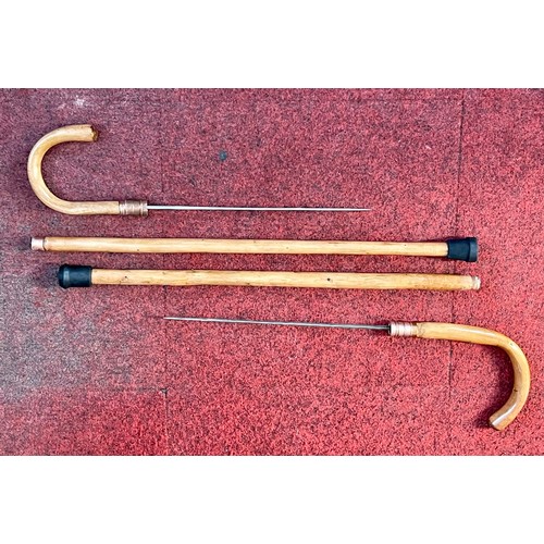 219 - A pair of unusual swordsticks in the form of walking sticks with rubber ends