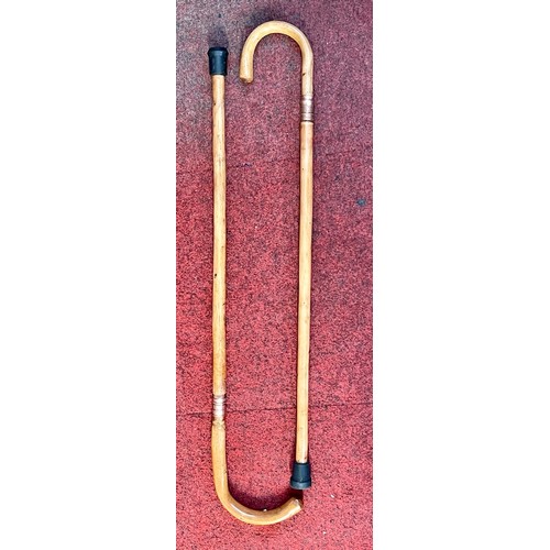 219 - A pair of unusual swordsticks in the form of walking sticks with rubber ends