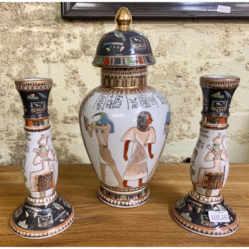 243 - EGYPTIAN STYLE HIGHLY DECORATED COVERED URN WITH A PAIR OF MATCHING CANDLESTICKS