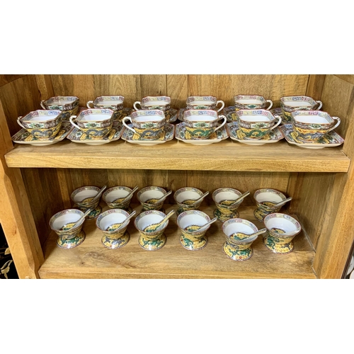 265 - A YELLOW GROUND DRAGON PATTERNED TEA AND SOUP BOWL SET - 12 SQUARE CUPS, SAUCERS TOGETHER WITH 12 SO... 