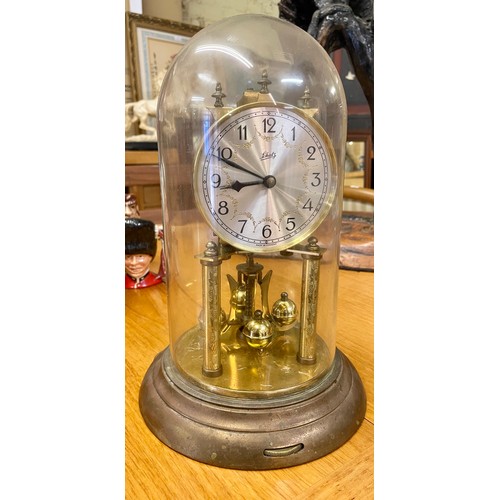 351A - LCHATZ BRASS CARRIDGE CLOCK ENCASED IN A GLASS DOME WITH KEY