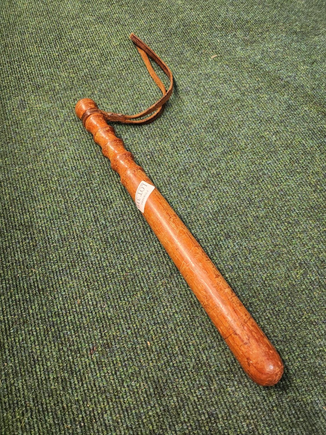 A TRUCHEON OR NIGHT STICK WITH LEATHER STRAP 39CM L