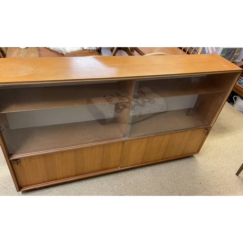 241 - A TEAK LONG JOHN BOOKCASE OF SLIDING GLASS DOORS ABOVE SLIDING CUPBOARD BASE, WITH ADJUSTABLE SHELVE... 