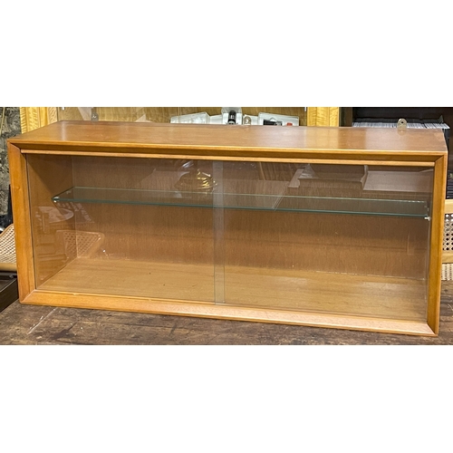 246 - A MID-CENTURY TEAK WALL MOUNTED CABINET WITH ADJUSTABLE SHELF AND SLIDING GLASS DOORS