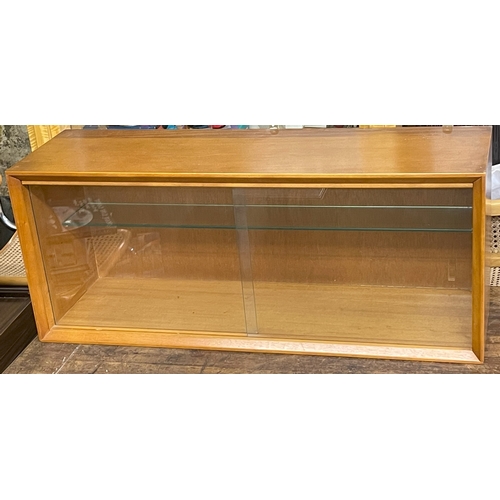 246 - A MID-CENTURY TEAK WALL MOUNTED CABINET WITH ADJUSTABLE SHELF AND SLIDING GLASS DOORS