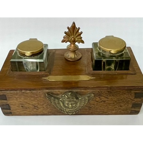 213 - AN OAK CASE INK STAND -WITH A PAIR OF BRASS LIDDED CUT GLASS GLASS INKWELLS THE CASE WITH A COPPER F... 