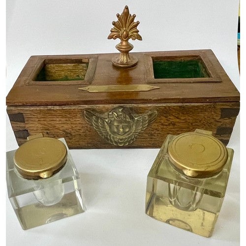 213 - AN OAK CASE INK STAND -WITH A PAIR OF BRASS LIDDED CUT GLASS GLASS INKWELLS THE CASE WITH A COPPER F... 