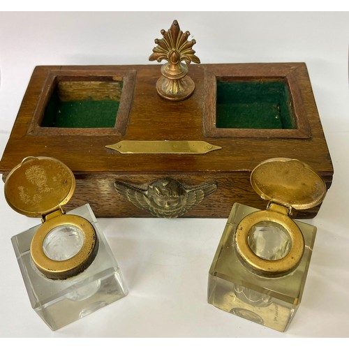 213 - AN OAK CASE INK STAND -WITH A PAIR OF BRASS LIDDED CUT GLASS GLASS INKWELLS THE CASE WITH A COPPER F... 