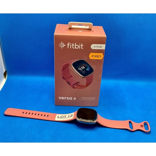 12 - BOXED FITBIT VERSA 4 FITNESS SMART WATCH IN COPPER ROSE WITH PINK INFINITY BAND