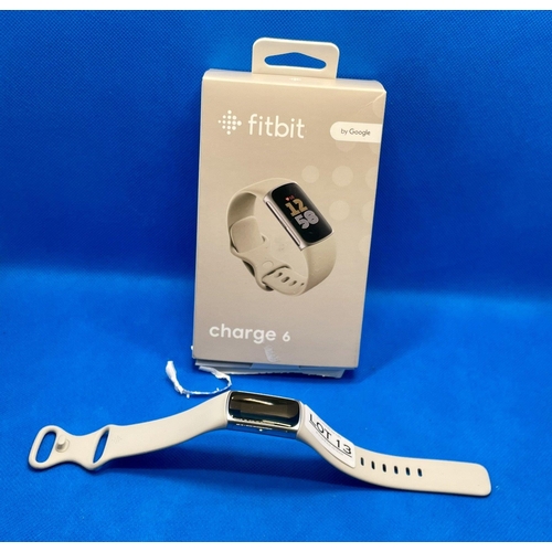 13 - BOXED FITBIT CHARGE 6 FITNESS TRACKER IN SLVER WITH PORCELAIN BAND