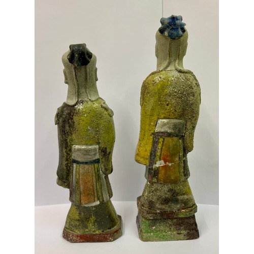 274 - TWO (2) CHINESE FIGURINES -ROUGH CAST  GLAZED WITH CHINESE CHARACTERS INSCRIBED TO THE ROBES -1 WITH... 