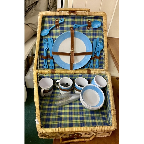 227 - A PICNIC SET - WHICKER BASKET WITH 4 PLACE SETTING PLASTIC CONTENTS