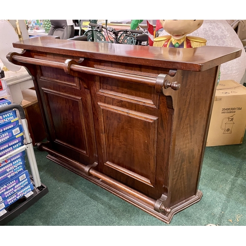 233 - A LARGE SHAPED MAHOGANY BAR WITH SHELVES INSET, FOOT AND HAND RAIL