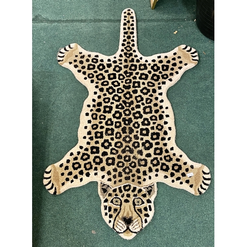 245 - AN UNUSUAL SHAPED RUG IN THE FORM OF A LEOPARD 150CM AT LONGEST POINT - 90CM WIDE