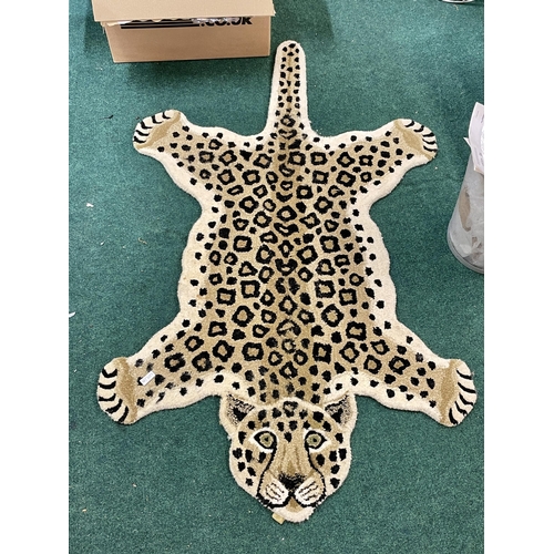 246 - AN UNUSUAL SHAPED RUG IN THE FORM OF A LEOPARD 150CM AT LONGEST POINT - 90CM WIDE