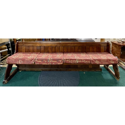 249 - AN ANTIQUE PINE PEW - 250CM LONG  X 81CM HIGH X 60CM DEEP WITH HYMN SHELF TO REAR (NB HAS BEEN FITTE... 