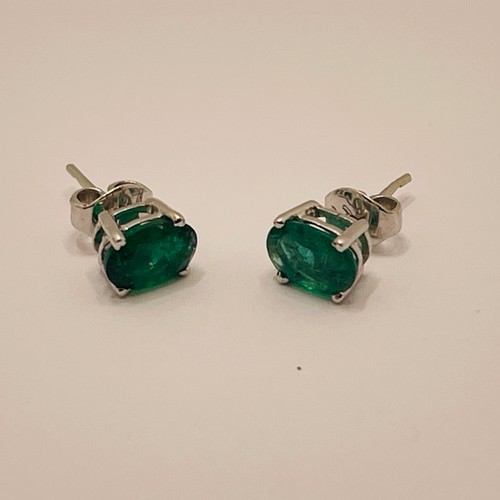 365 - A PAIR OF CLAW SET OVAL EMERALD AND WHITE GOLD EARRINGS - TESTED AS 14CT WHITE GOLD -EACH EMERALD AP... 