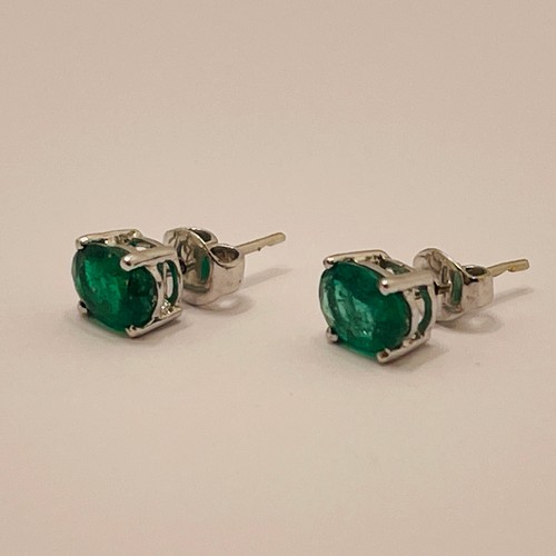 365 - A PAIR OF CLAW SET OVAL EMERALD AND WHITE GOLD EARRINGS - TESTED AS 14CT WHITE GOLD -EACH EMERALD AP... 