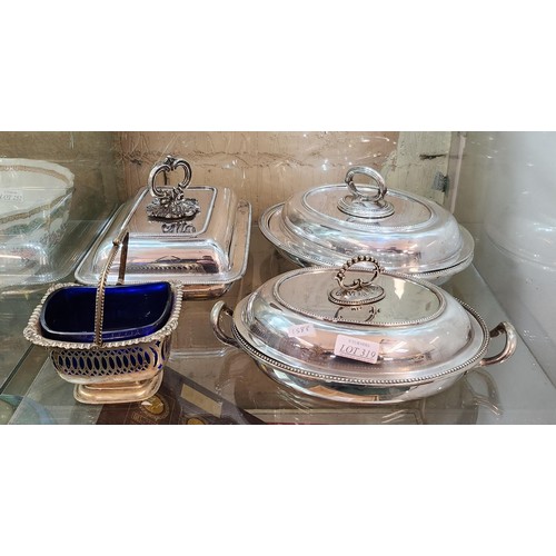 319 - 3 X SILVER PLATED SERVING DISHES WITH LIDS TOGETHER WITH A PLATED FRETWORK BASKED WITH BLUE GLASS LI... 