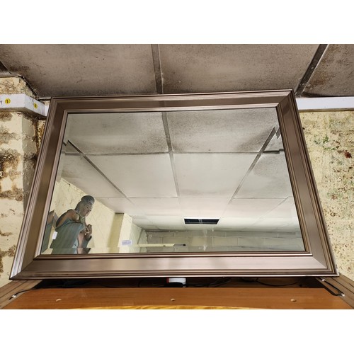 358 - A LARGE RECTANGULAR FRAMED MIRROR WITH BEVELLLED EDGE -SILVER COLOURED WOODEN SURROUND - SOME WEAR C... 