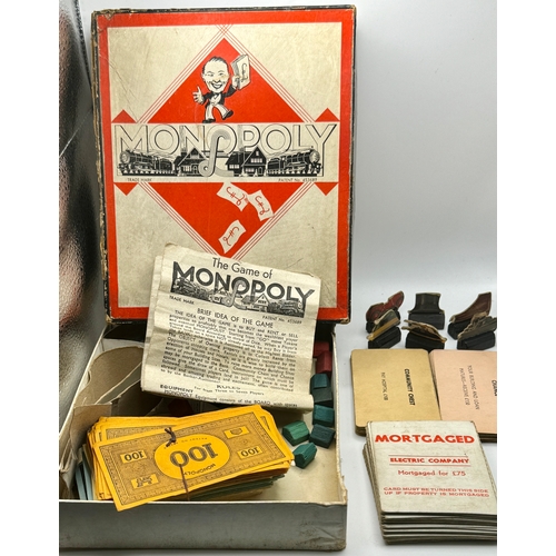 219 - A VINTAGE MONOPOLY SET - ORIGINAL BOX WITH CARDBOARD PIECES AND A SET OF PLASTIC DRAUGHSTMEN