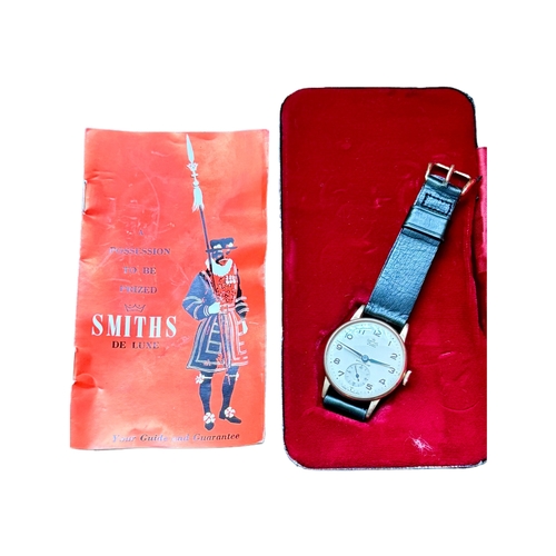 329 - A SMITHS DE LUXE 9CT Y/GOLD MECHANICAL WRIST WATCH INSCRIBED TO REAR ORIGINAL BOX GUIDE AND GUARANTE... 