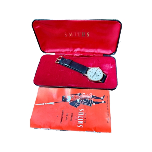 329 - A SMITHS DE LUXE 9CT Y/GOLD MECHANICAL WRIST WATCH INSCRIBED TO REAR ORIGINAL BOX GUIDE AND GUARANTE... 