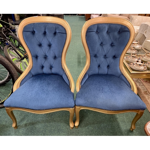 298 - A PAIR OF GILDED AND BLUE DRALON BUTTON BACK NURSING CHAIRS