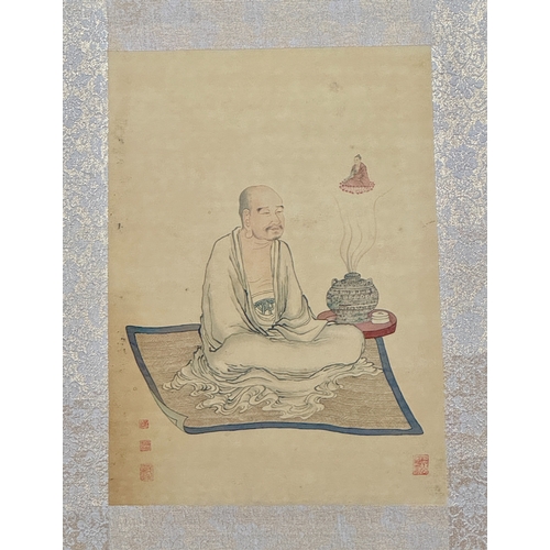 402 - AN OLD CHINESE PICTURE ON A SILK LIKE MATERIAL WITHIN A PATTERNED SILK BORDER - SHOWING A BUDDHIST F... 