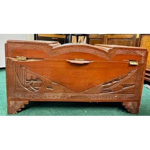 294 - A HEAVILY CARVED CAMPHOR WOOD ORIENTAL CHEST WITH SAILING BOATS TO VARIOUS PANELS, SHAPED OVAL CENTR... 