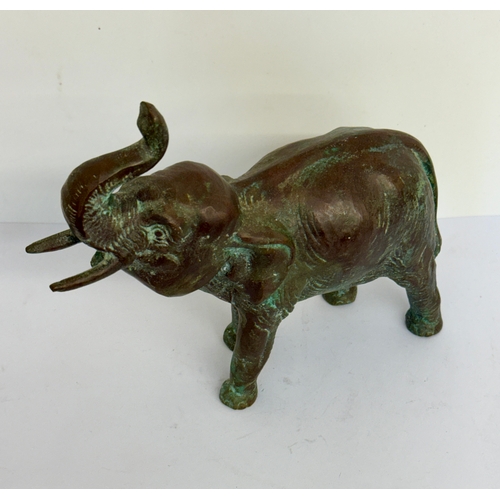 380 - A HEAVY BRONZE ELEPHANT FIGURE - TRUNK RAISED AND BELLOWING -SOUTH ASIAN, APPROX 18CMS LONG AND 1150... 