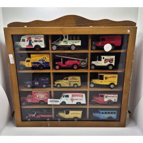 229 - A CASED GLAZED DISPLAY OF 12 MODEL CARS BY CORGI, LLEDO, OXFORD AND DAYS GONE -VINTAGE ADVERTISING W... 