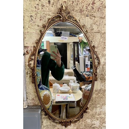 382 - GILT FRAMED ROCCOCO STYLE OVAL MIRROR