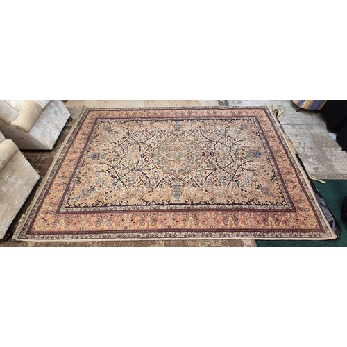 380 - LARGE AFGHAN STYLE RUG DECORATED WITH FLOWERS AND URNS - NOTE TASSLES HAVE BEEN TAPED - APPROX 315CM... 