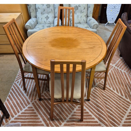A MORRIS OF GLASGOW CHERRYWOOD CIRCULAR EXTENDING DINING TABLE & 4