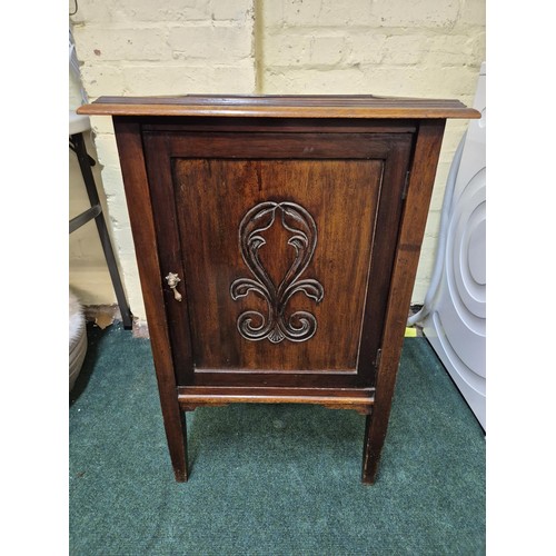 231 - A SQUARE OAK ART NOUVEAU STYLE CABINET ON RAISED LEGS WITH CARVED SINGLE DOOR AND GALLERIED TOP