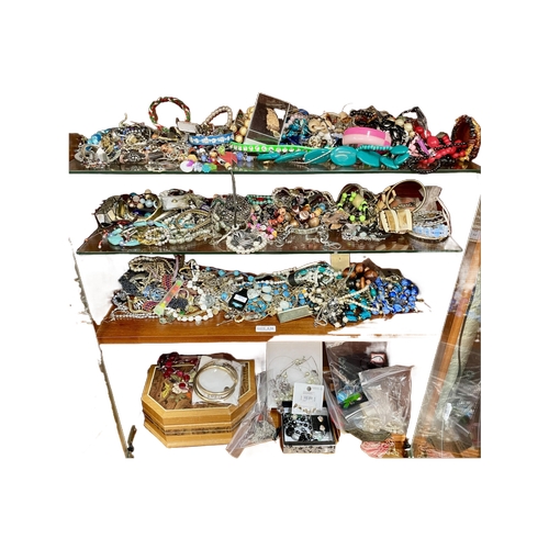 428 - 4 X SHELVES OF VARIOUS COSTUME JEWELLERY - NECKLACES, BANGLES, BROOCHES AND A JEWELLERY BOX