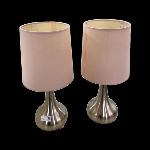 434 - A PAIR OF DUNELM CHROMED TOUCH BEDSIDE LAMPS WITH PINK SHADES