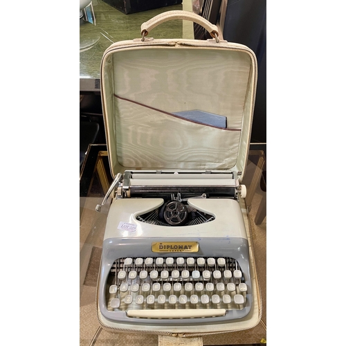 329 - A CASED DIPLOMATE SUPER PORTABLE MANUAL TYPEWRITER WITH MANUAL, RIBBON