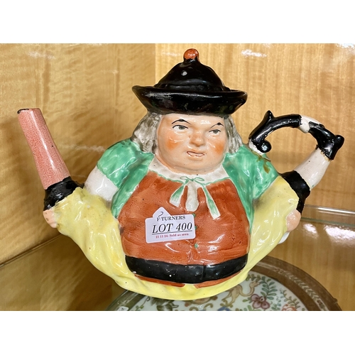 400 - A VICTORIAN COMICAL TEAPOT WITH LID OF A FIGURE HOLDING HIS LEGS -DGE TO SPOUT