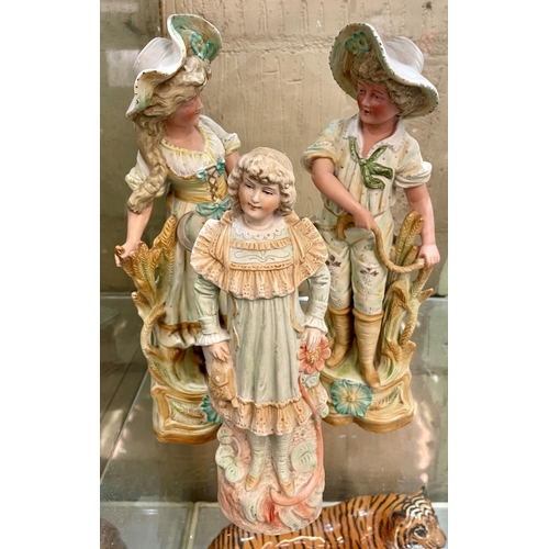 433 - 3 X EARLY 20TH C. GERMAN BISQUE FIGURINES - CHILD WITH A BAG AND FLOWER AND 2 X FIGURES REPRESENTING... 