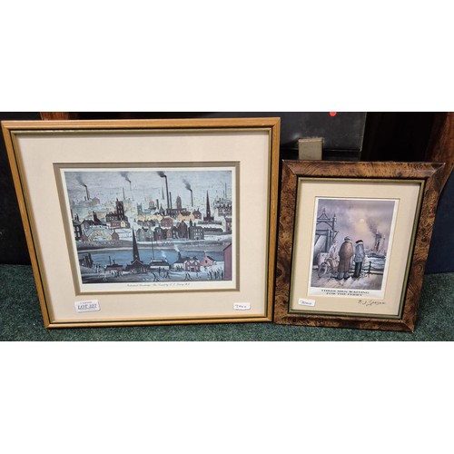 327 - A SMALL LOWRY PRINT OF A CANAL FRAMED AND GLAZED, TOGETHER WITH A SMALL FRAMED CARTOON -THREE MEN WA... 