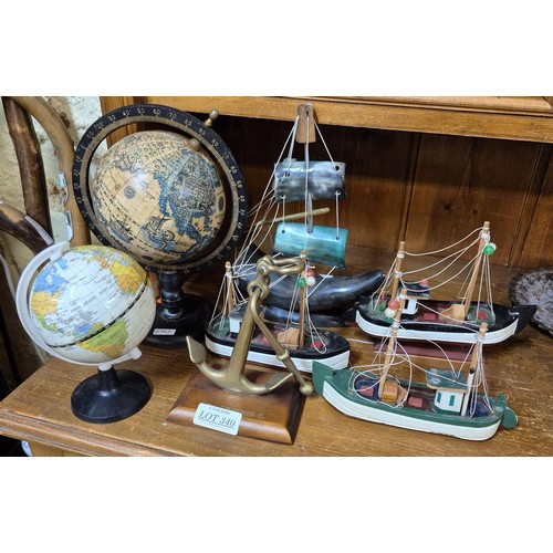 340 - X2 MINIATURE GLOBES, X4 MODEL BOATS AND AN ANCHOR ORNAMNET MARKED TN EUGENIO