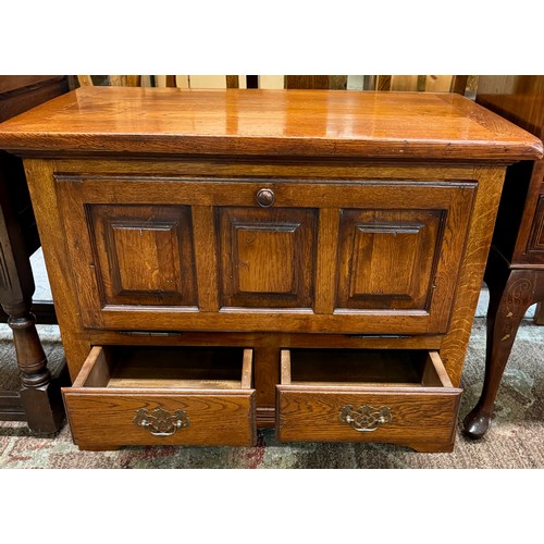 319 - A HEAVY OAK FALL FRONT CABINET IN THE FORM OF A COFFER, A DROP FRONT CUPBARD ABOVE TWO DRAWERS 82CM ... 