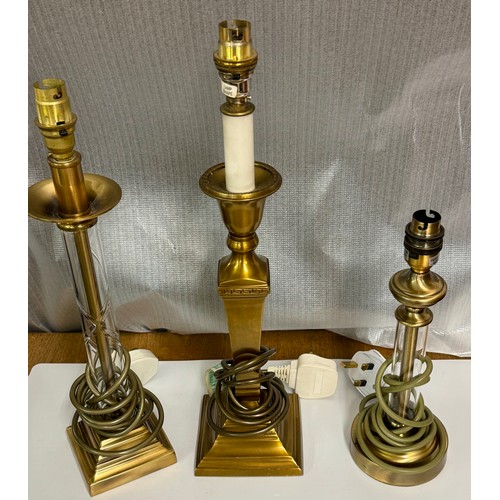 392 - THREE (3) MODERN BRASS COLUMN TABLE LAMPS - 2 WITH GLASS SHEATHS THE OTHER COLUMNAR -ALL MODERN WIRE... 